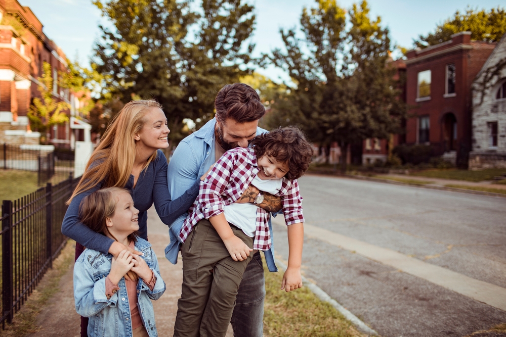 Family walking after moving to a new neighborhood