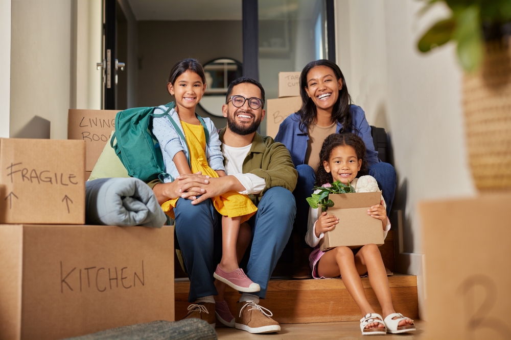 Young family moving with packed boxes