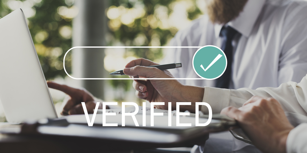 Businessman with verified checkmark concept